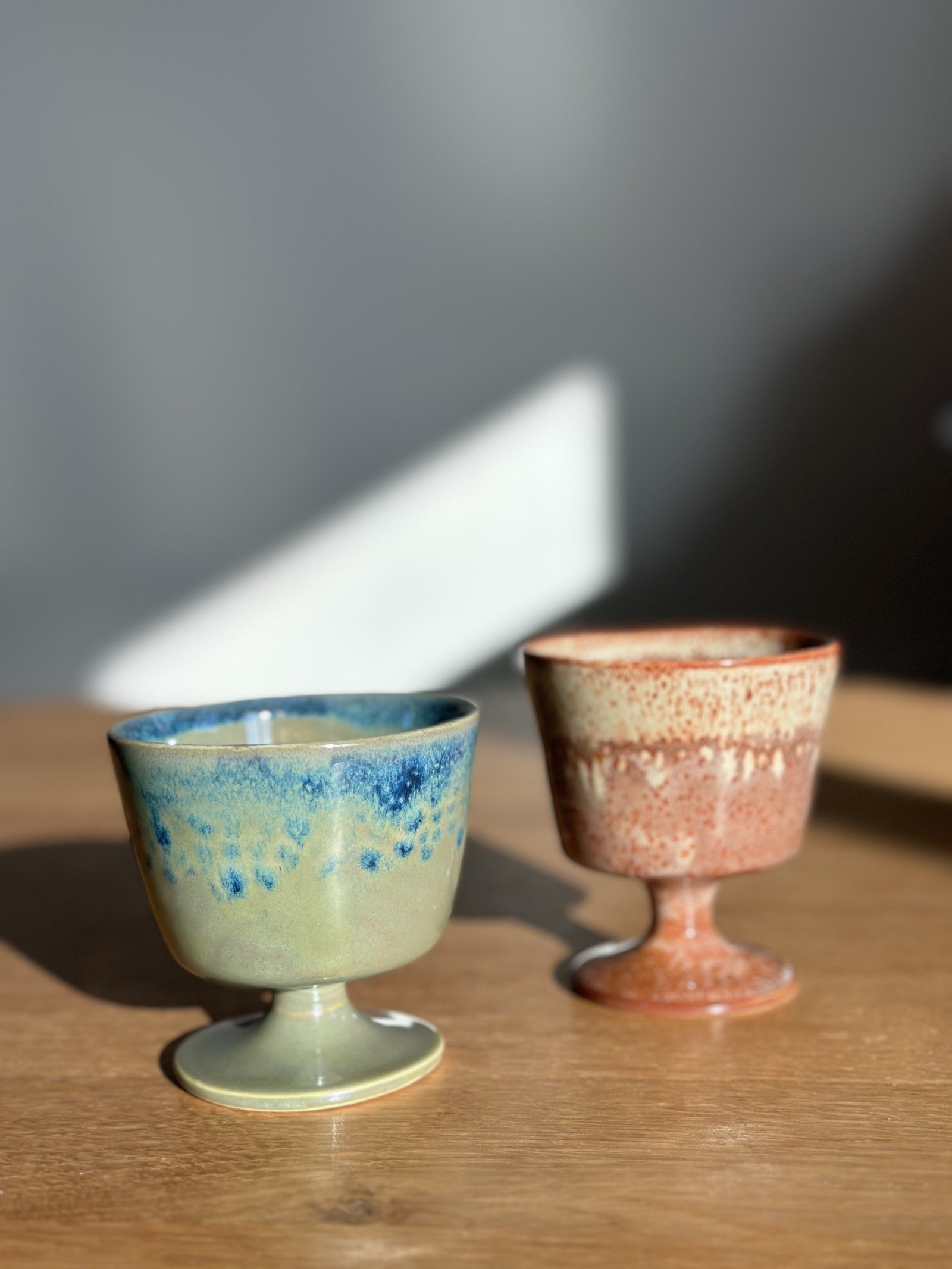 Two ceramic goblets with blue and rust glazes